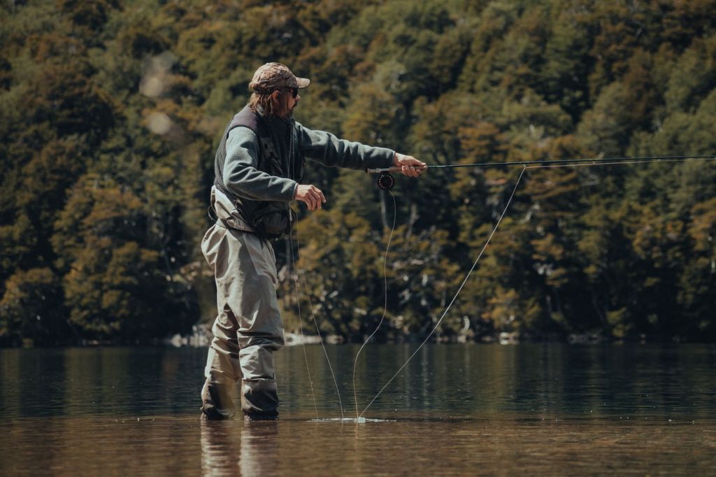 An angler casting a fly line on a river