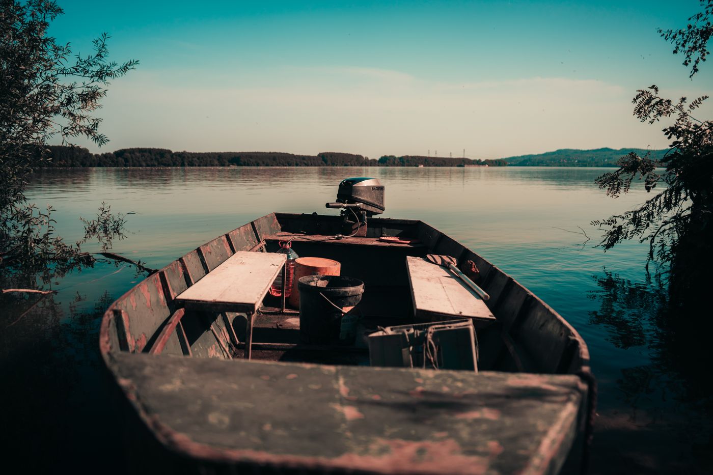 A wooden boat moored on a calm lake