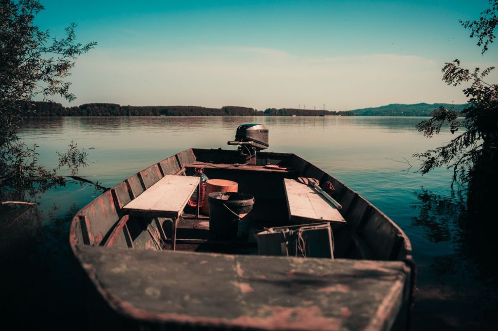 A wooden boat moored on a calm lake