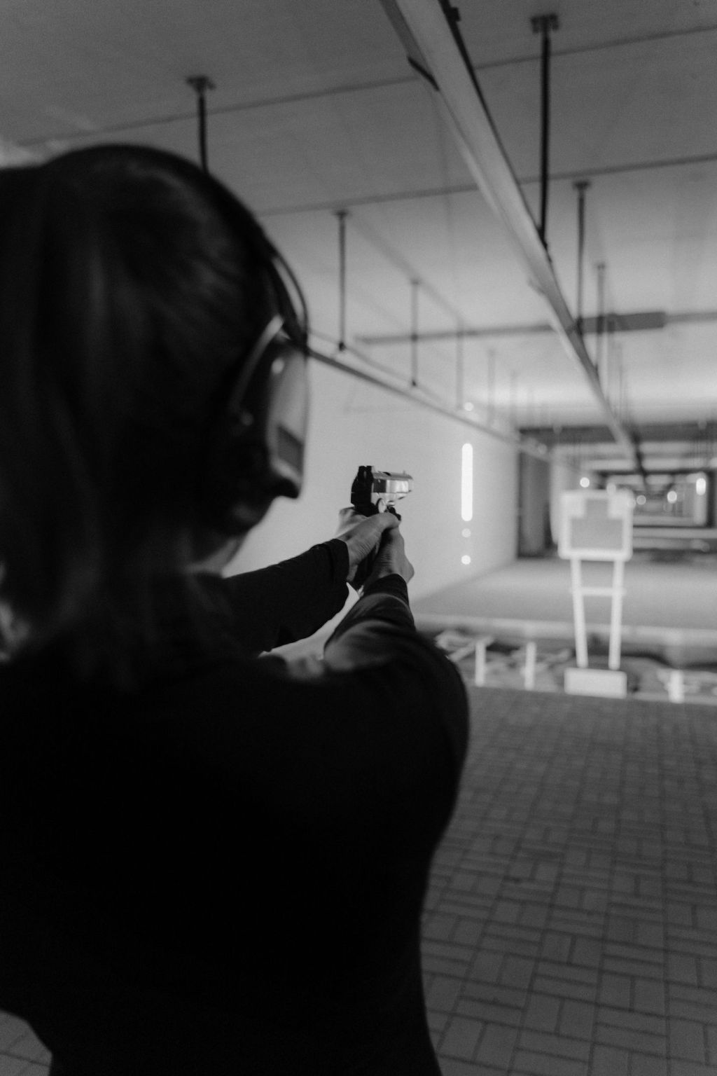 A shooter with ear protection on an indoor range