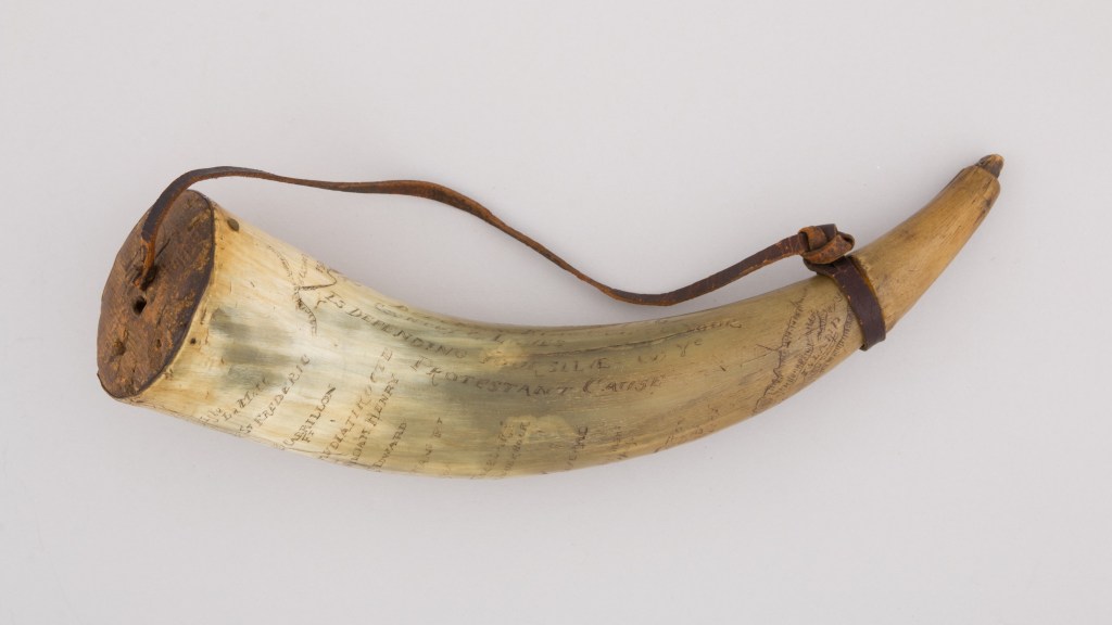 An engraved powder horn used for carrying black powder
