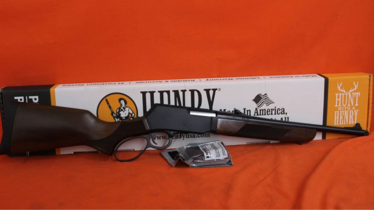 A Henry lever-action rifle in front of its box