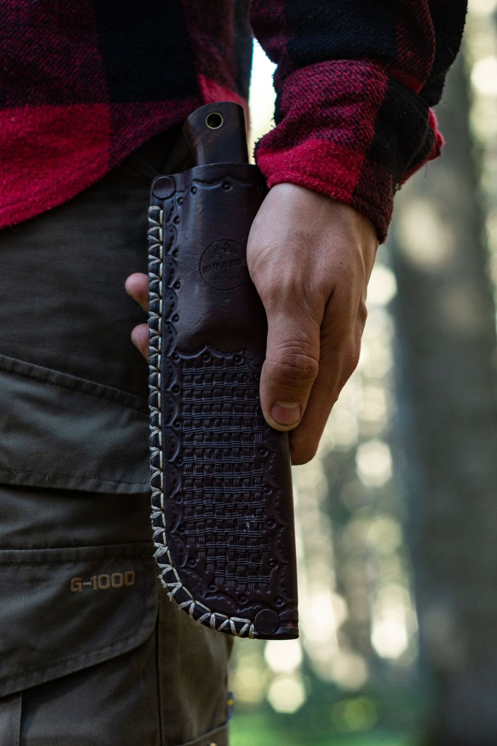 A knife carried in a leather belt sheath