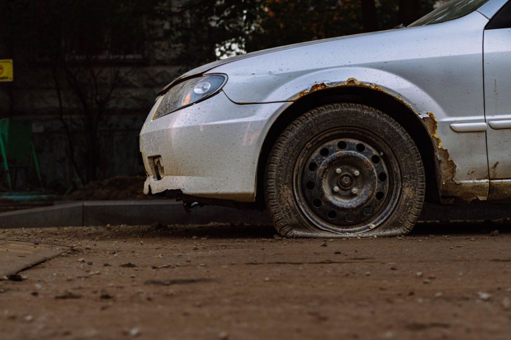 A vehicle fender caked in dried mud