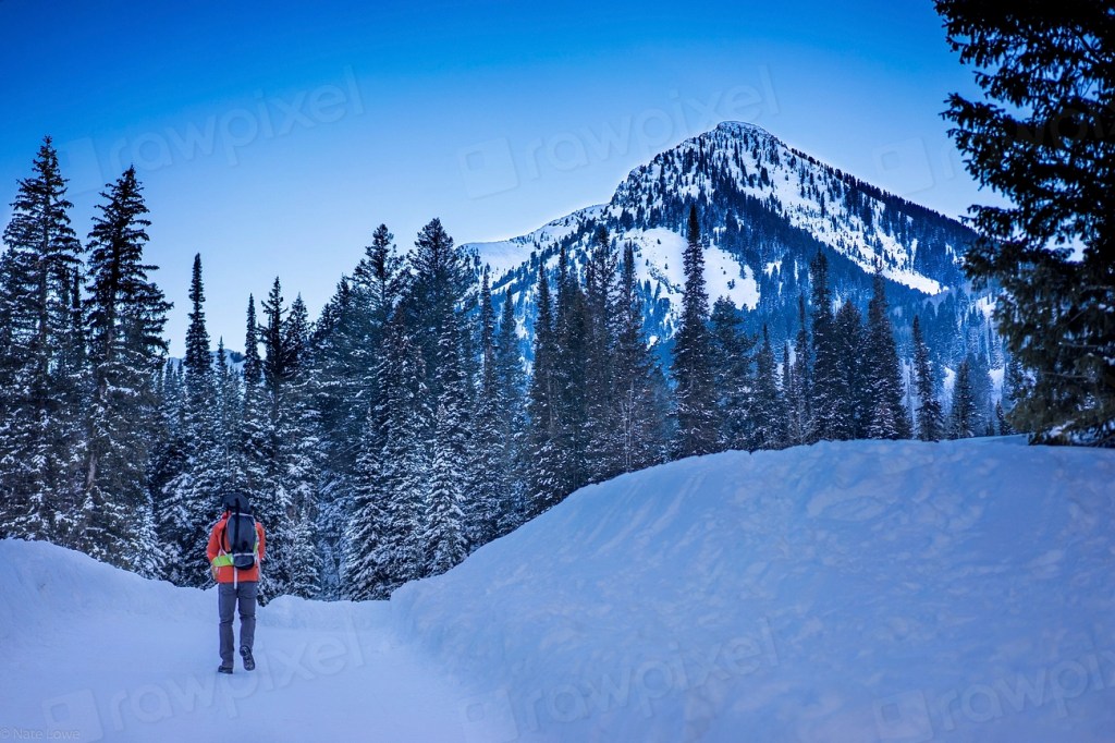 Hikers heading uphill through snow on a winter trip