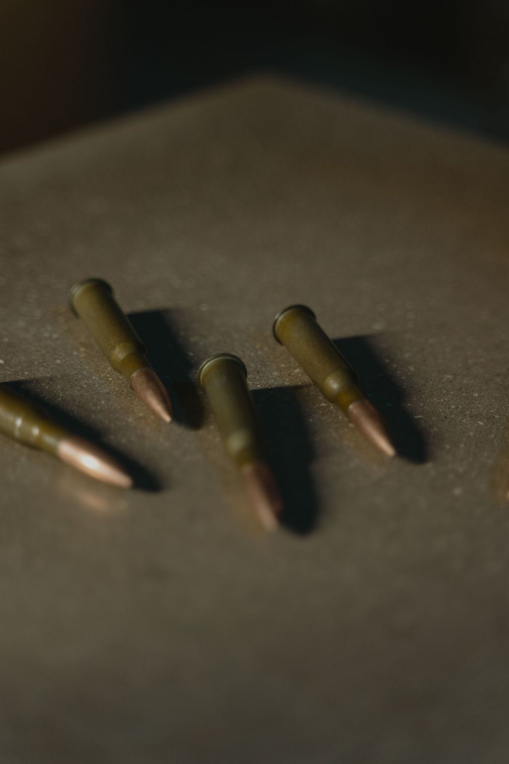 Rifle cartridges resting on a wooden surface