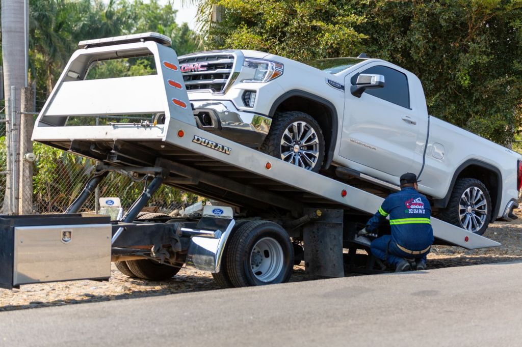 A pickup truck loaded on a flatbed recovery truck
