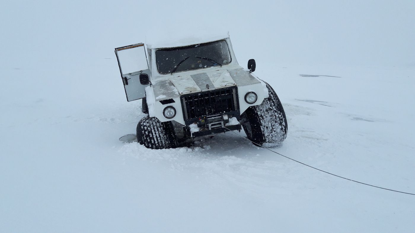 A vehicle being recovered in deep snow