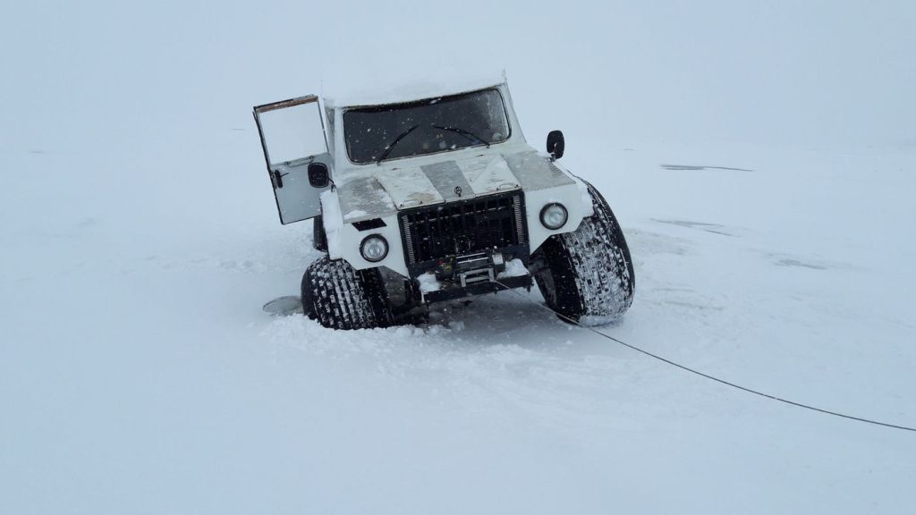 A vehicle being recovered in deep snow